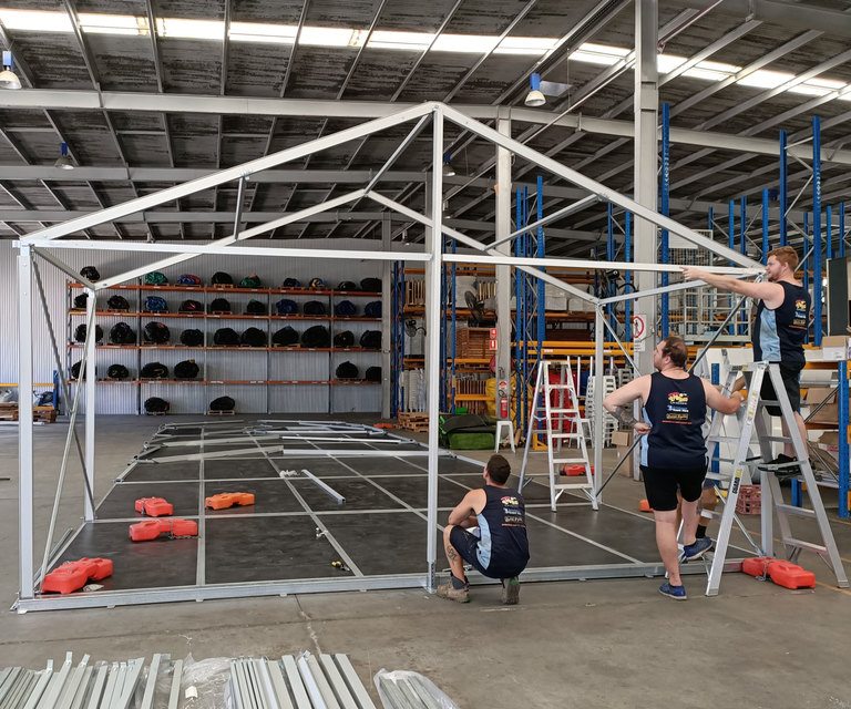 Assembling A Marquee In Warehouse