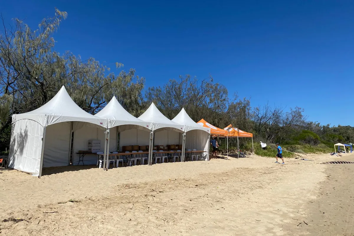 Row of white pagoda marquees set up side by side