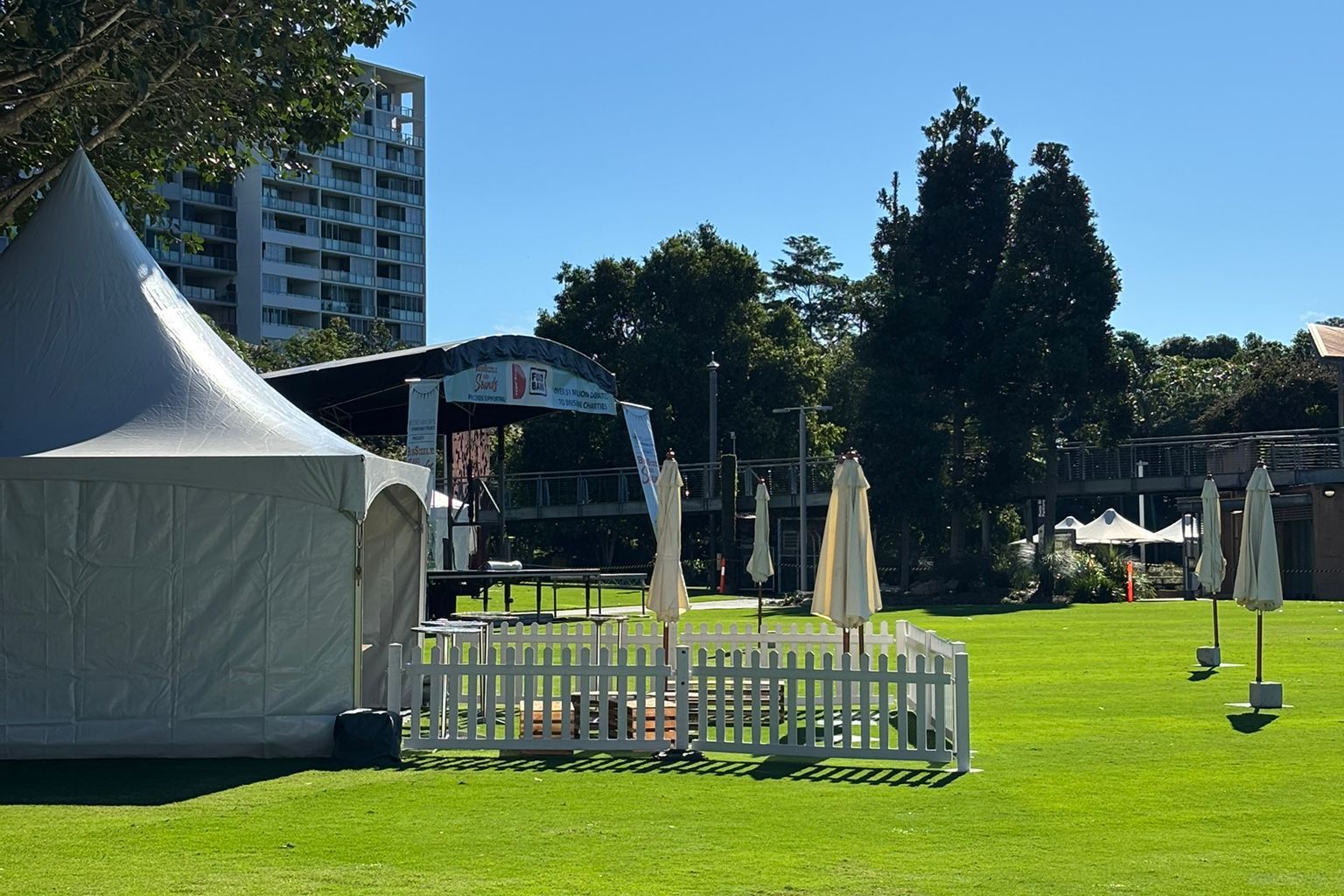 White pagoda beside a picket fence on a sunny lawn