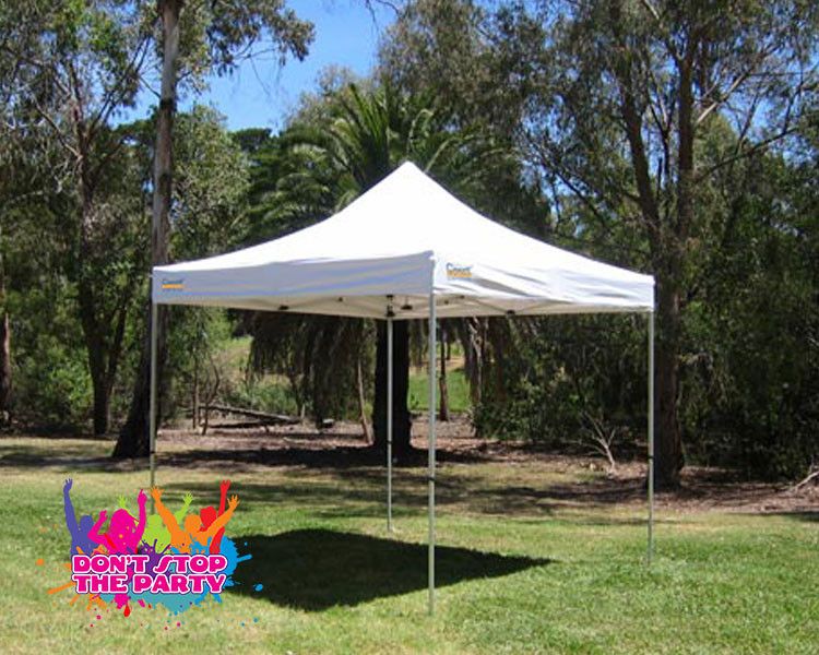 White pop-up gazebo on a lawn under trees